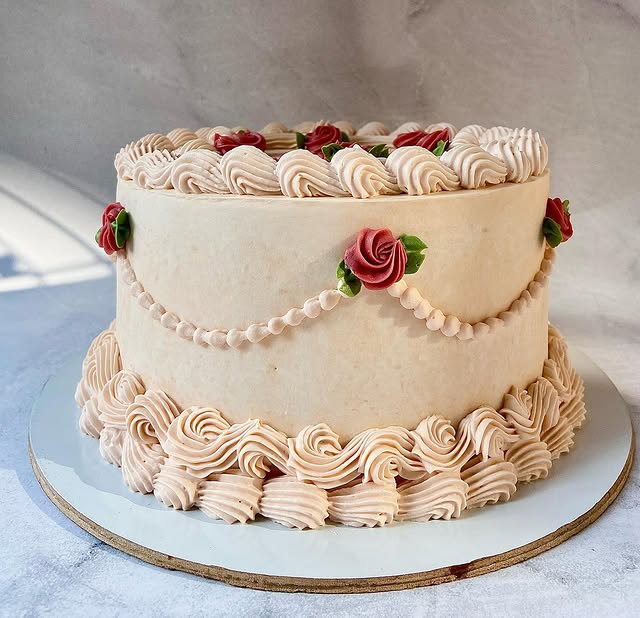 Lambeth-style cake with piped shell borders and buttercream roses